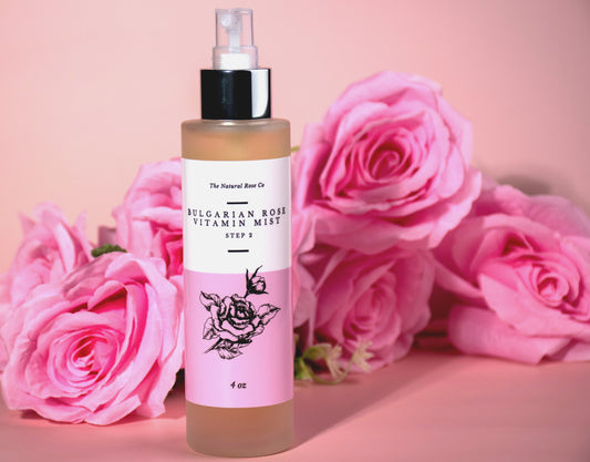 The Natural Rose Natural Rosewater Facial Toner bottle with pink roses on a soft pink background