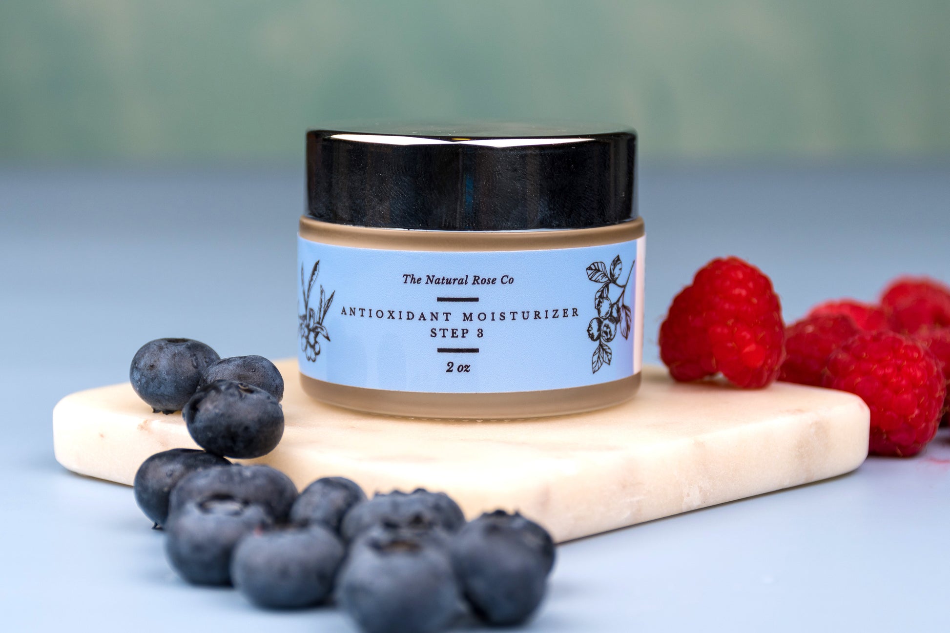The Natural Rose natural skincare antioxidant cream antioxidant moisturizer in jar with blueberries and raspberries